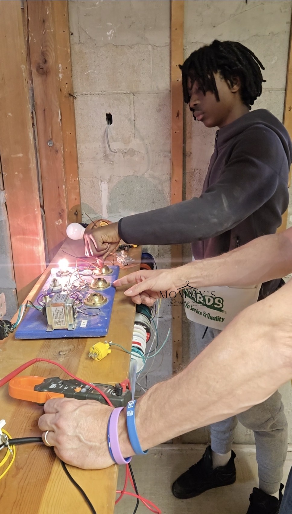 Teen learning electrical wiring at trade school
