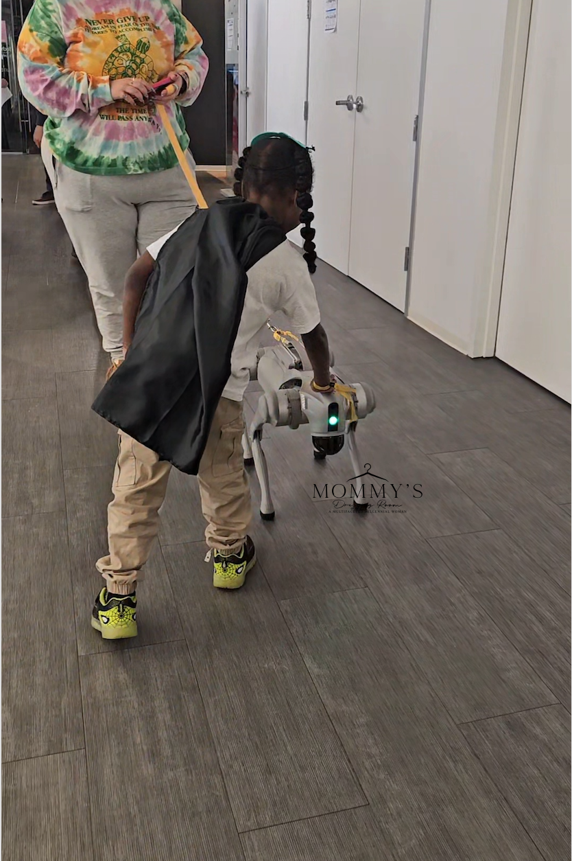 4-year-old interacting with robot at coding event